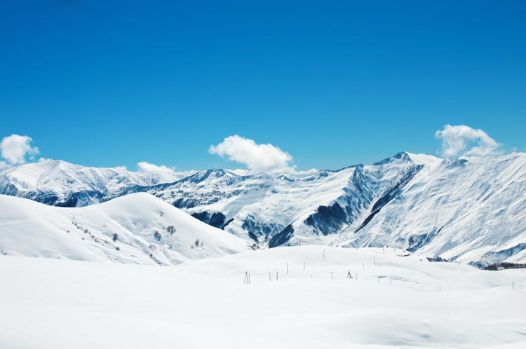Scenic snow-covered mountain landscape with clear sky, ideal for winter sports and outdoor adventures
