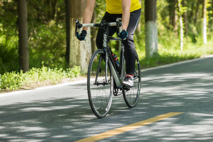 Cyclist wearing heated glove liners while commuting on a bike, enjoying warm and comfortable rides in cold weather
