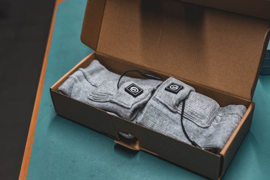 Rechargeable heated socks with battery pack in packaging box