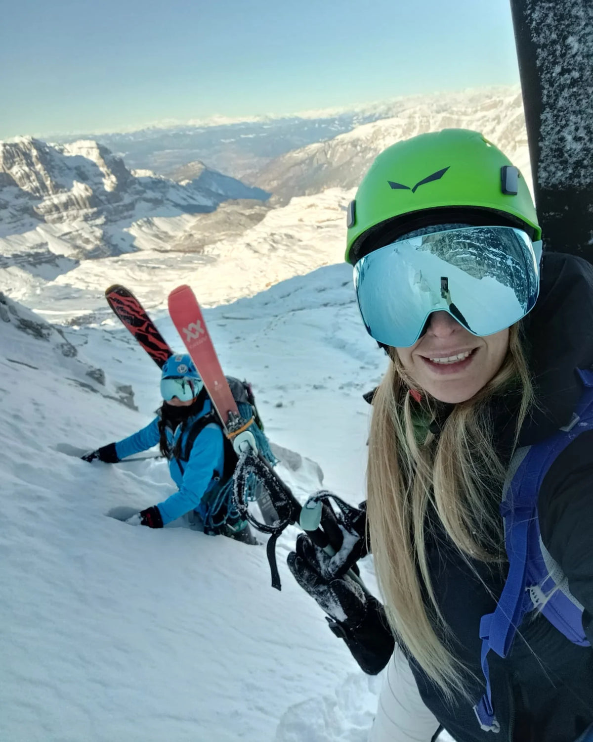 Skiers wearing SAVIOR HEAT heated gloves during a snowy mountain adventure