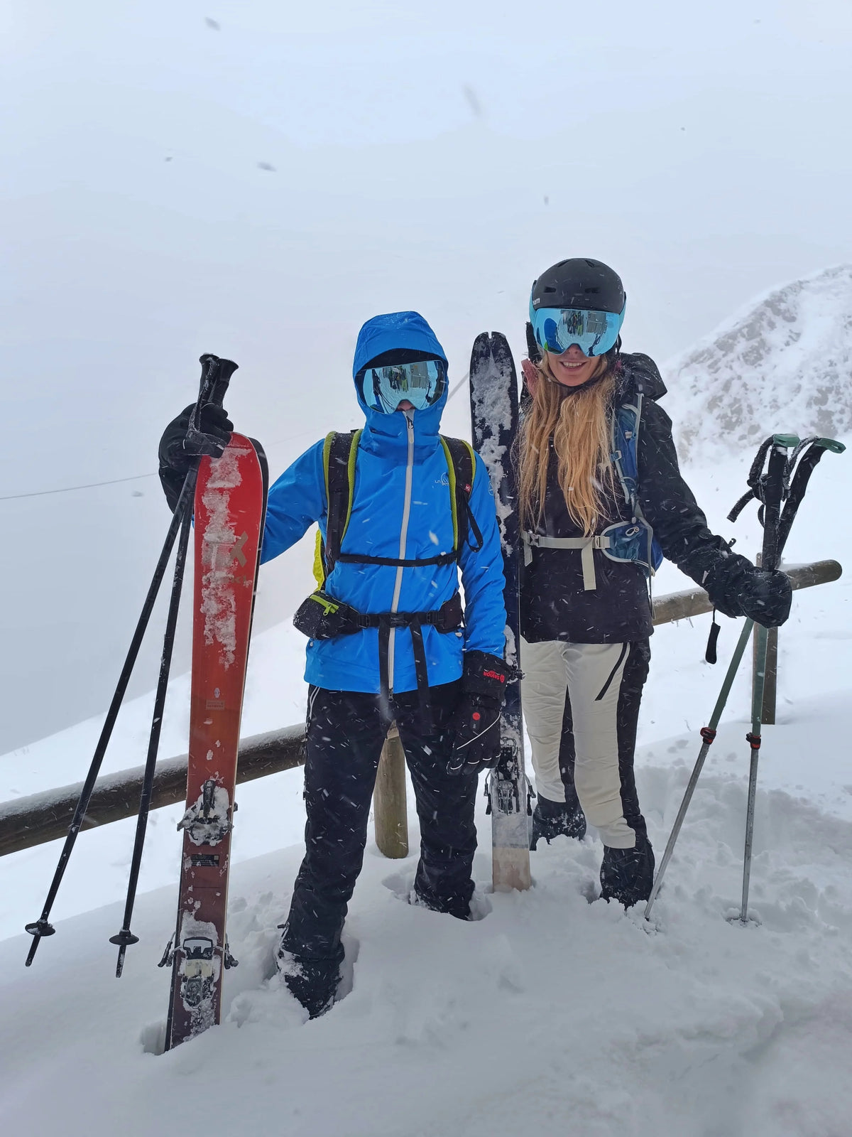 Skiers wearing SAVIOR HEAT heated gloves in deep snow and cold mountain conditions